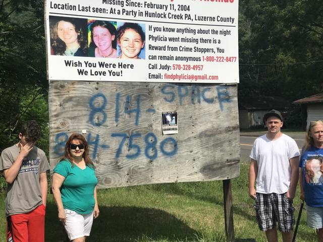 
			
				                                Pauline Bailey, far right, stand beneath the billboard that was installed Monday morning on Route 11 in West Nanticoke seeking people to come forward with information on the disappearance of her daughter, Phylicia Thomas. From left are: Jesse Thomas, Bailey’s grandson, Judy Lorah Fisher, Bailey’s friend who has been spearheading the search for Phylicia; and Wade Thomas, Bailey’s son.
                                 Bill O’Boyle | Times Leader

			
		