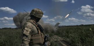 
			
				                                A Ukrainian soldier watches a Grad multiple launch rocket system firing shells with flyers near Bakhmut, Donetsk region, Ukraine, on Sunday.
 
			
		